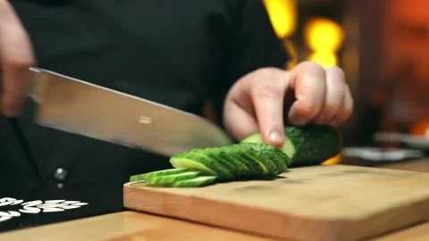 Slicing of a cucumber in the restaurant kitchen Stock Footage 153162244