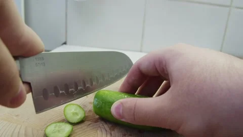 Slicing cucumbers on a cutting board Video stock 286842560