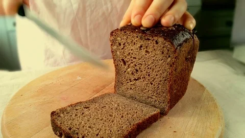 Slicing dark bread Stock Footage 82770706