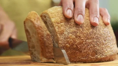 Slicing delicious bread on a cutting board. Stock Footage 169797466