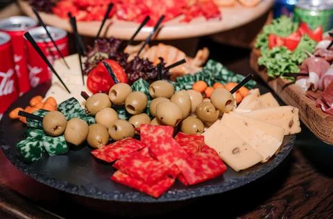 Slicing different types of cheese and olives. Buffet Stock Photos