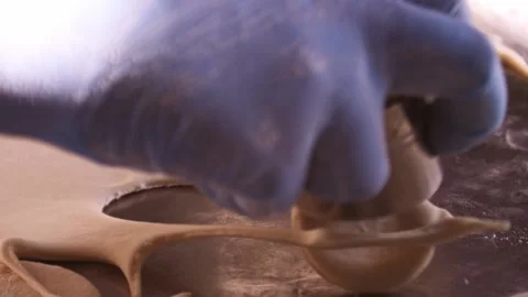 Slicing dough with a round form cutter Stock Footage 148728153