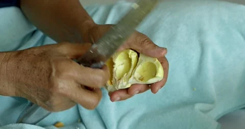 Slicing durian fruit culinary adventure in a kitchen food preparation close-up Stock Footage 337487167