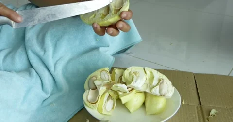 Slicing durian fruit delightfully kitchen table food bright atmosphere close-up Stock Footage 337487289