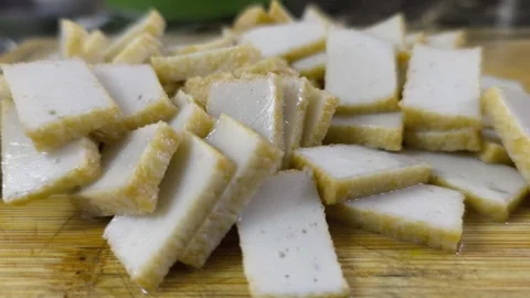 Slicing Fish Cake on a Chopping Board Stock Footage 320523953