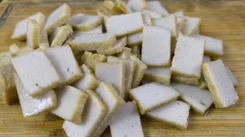 Slicing Fish Cake on a Chopping Board Stock Footage 320523972