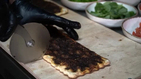 Slicing Flatbread with Pizza Cutter Stock Footage 319950609