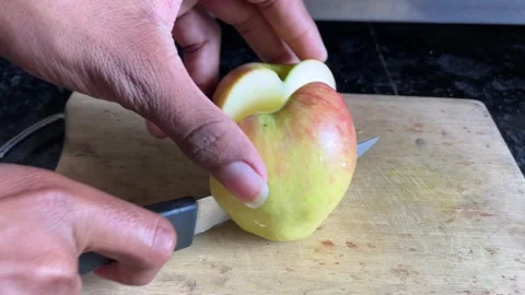 Slicing a Fresh Apple on a Cutting Board with a Knife Stock Footage 321127567