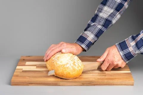 Slicing Fresh Bread on Cutting Board Stock Photos