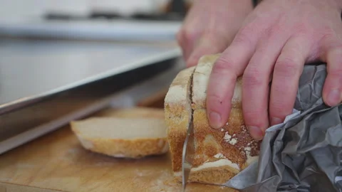 Slicing Fresh Bread with Knife in Scandinavian Kitchen Stock Footage 328016231