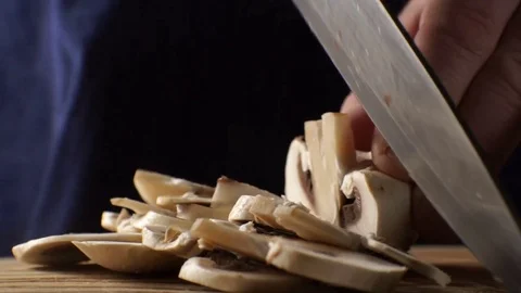 Slicing fresh champignons into thin slices. Video Stock Footage 85329430