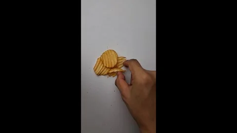 Slicing Fresh Crispy Potato Chips on White Surface Stock Footage 337785822