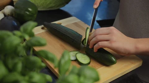 Slicing a fresh cucumber. A large ripe cucumber. Outline. Diet. Organic Cucumber Stock Footage 263442944