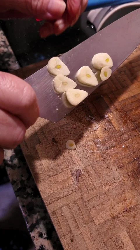 Slicing fresh garlic on cutting board at home. Stock Footage 344967551