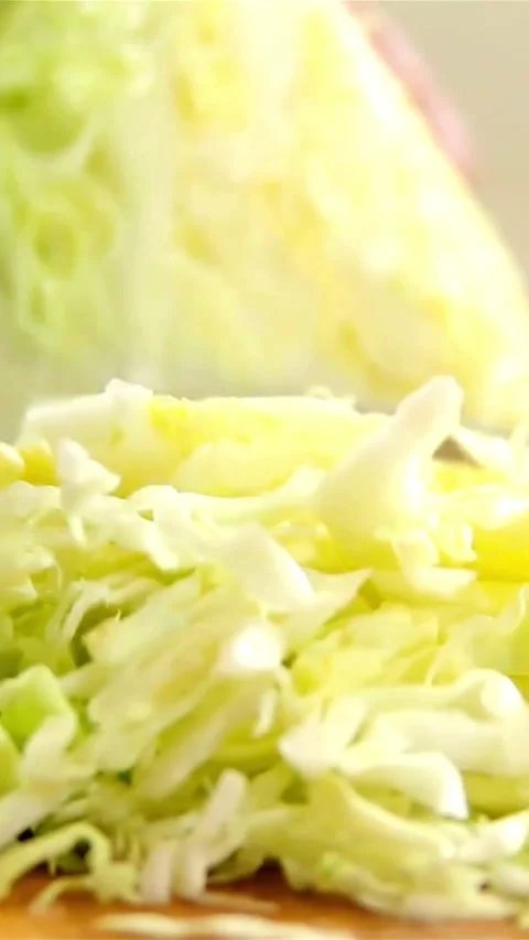 Slicing fresh green cabbage head with knife on board Stock Footage 334170881