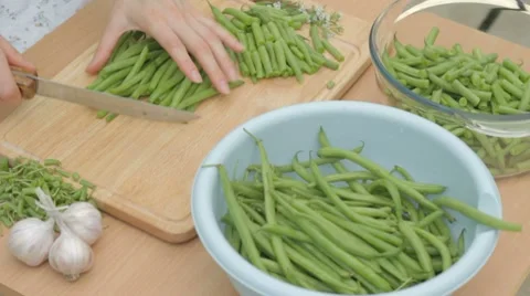 Slicing fresh green string beans in equal parts on board Stock-Footage 8367347