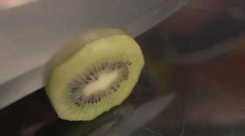 Slicing a fresh Kiwi Stock Footage 62598059