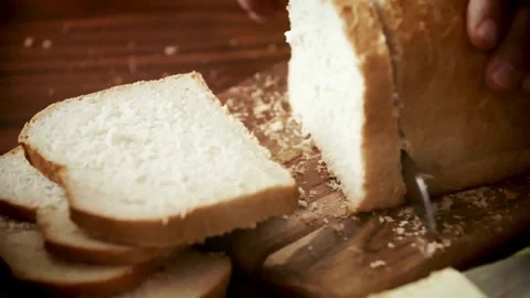 Slicing Fresh Loaf of White Bread on Wooden Board Stock-Footage 333739478
