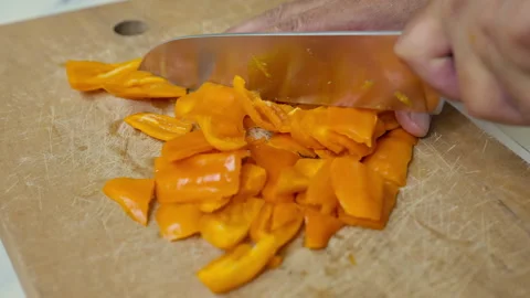 Slicing fresh Peruvian yellow chili peppers (Aji Amarillo) Stock Footage 341438229