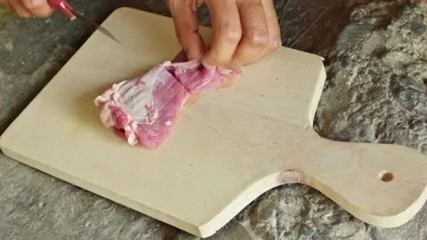 Slicing Fresh Raw Beef with Sharp Knife on Wooden Cutting Board for Traditi.. Stock-Footage 337954234