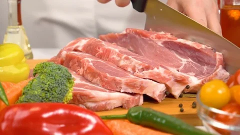 Slicing fresh raw meat for cooking in slow motion Stock Footage 85360456