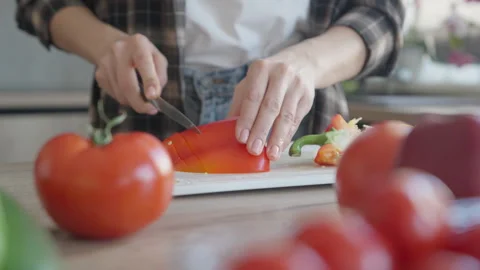 Slicing Fresh Red Bell Pepper On Cutting Board For Healthy Homemade Salad Stock Footage 308454020
