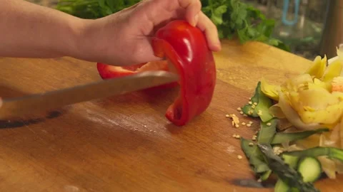 Slicing fresh red bell pepper on wooden cutting board Video stock 331314010