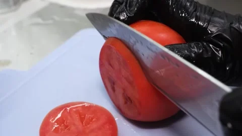 Slicing Fresh Red Tomato on a Cutting Board Stock Footage 331633115