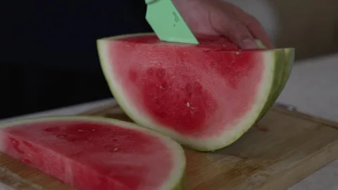 Slicing fresh red watermelon wedge on wooden board Stock Footage 338120107