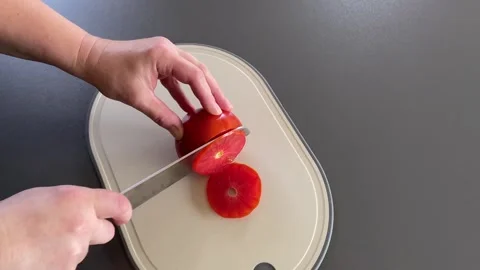 Slicing fresh tomato now Stock Footage 341983276