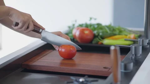 Slicing fresh tomatoes on kitchen cutting board Stock Footage 336466136