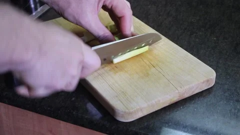 Slicing fresh vegetables in a kitchen environment for meal preparation Stock Footage 294623184