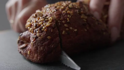 Slicing Freshly Baked Multigrain Bread Stock Footage 285566763