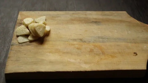 Slicing garlic in a kitchen environment Stock Footage 124687813