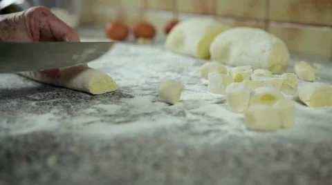Slicing gnocchi with a knife. Stock Footage 47231046