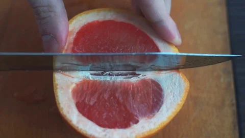 Slicing grapefruit in slow motion Stock Footage 86682844