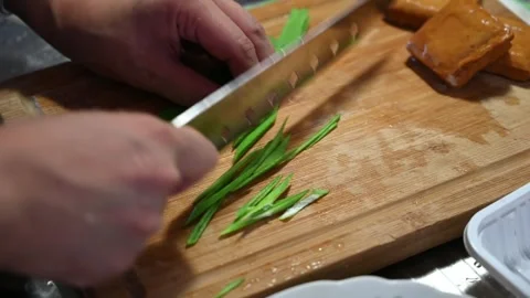 Slicing Green Garlic Sprouts for a Cold Dish Video stock 346487267
