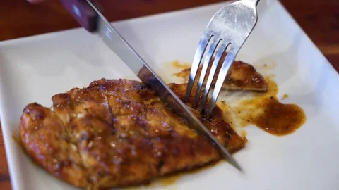 Slicing of grilled chicken on serving plate Stock Footage 81697465
