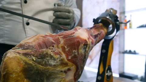 Slicing Hamon iberico. Prosciutto close up. Chef cuts a slice of ham Video stock 108310336