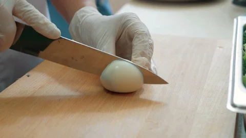 Slicing hard boiled eggs in half Stock Footage 96146668