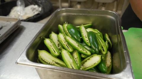 Slicing jalapenos in half Stock Footage 332837769