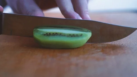 Slicing kiwi in slow motion Stock Footage 86682885