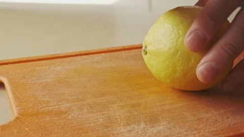 Slicing lemon with a knife Stock Footage 136726366