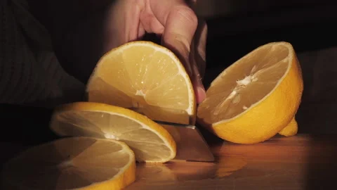 Slicing a lemon with a knife - Slow motion - Home cook or restaurant - Nutrition Stock Footage 130742511