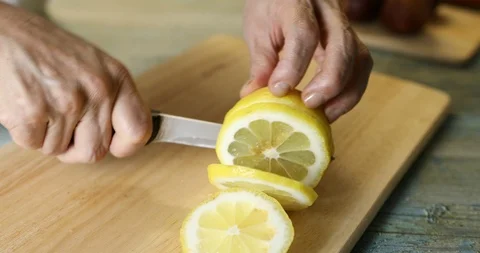 Slicing lemon to make fresh fig preserve Stock Footage 115930950