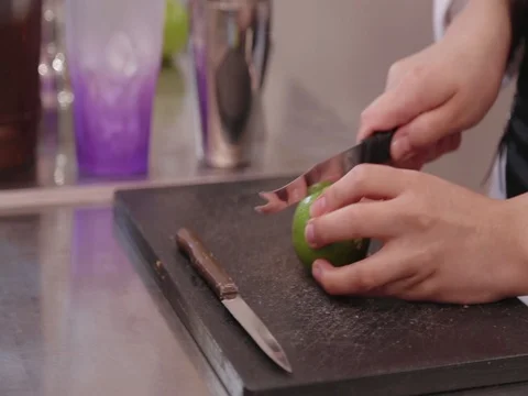 Slicing Lime with a knife on a table Video stock 80679043