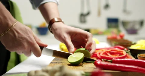 Slicing a lime preparing vegetables for a taco dinner Stock Footage 61535033