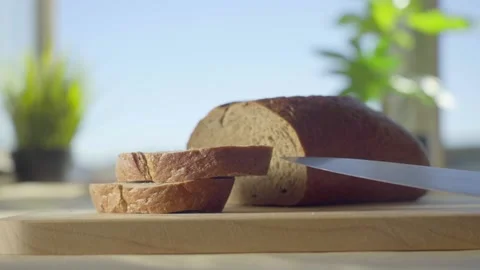 Slicing a Loaf of Bread in the Kitchen Stock Footage 151278507