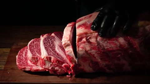 Slicing Meat with Knife on Cutting Board Stock Footage 334909400