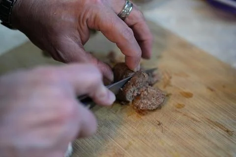 Slicing meatballs in a kitchen Foto stock
